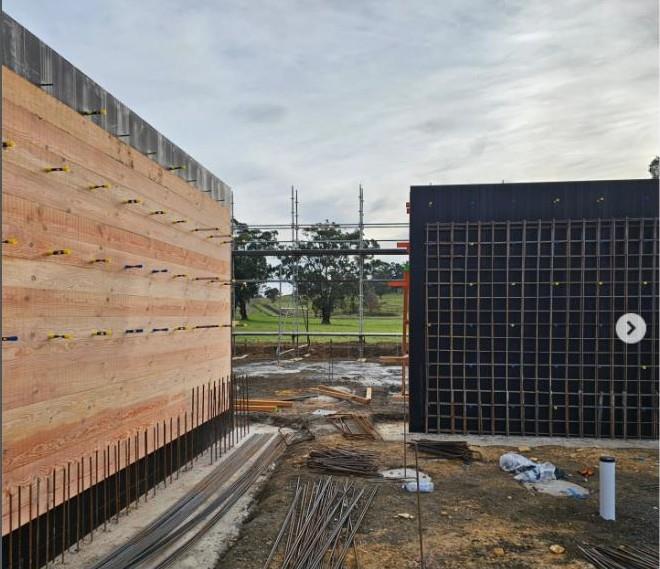 Board-form timber and black formwork walls